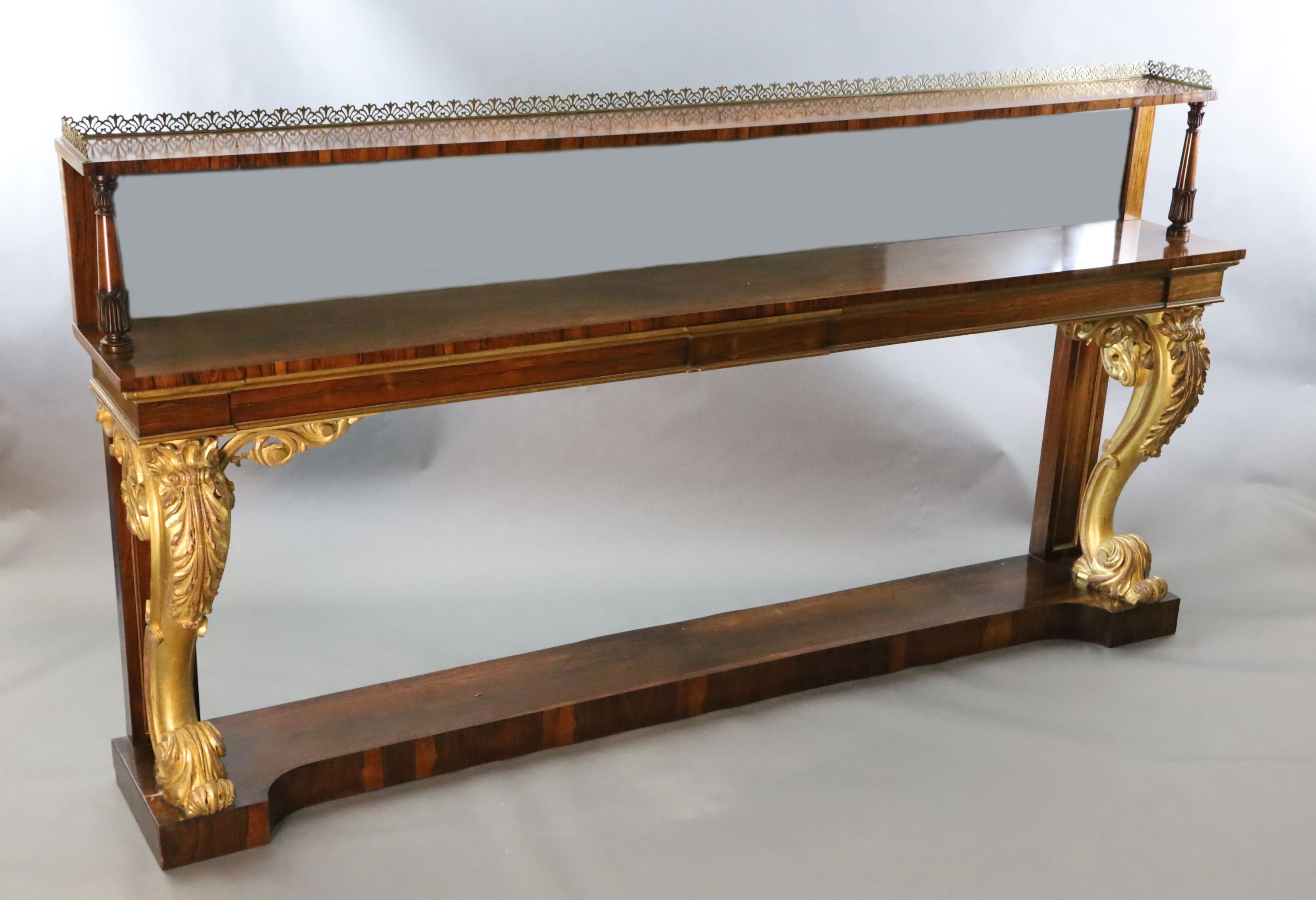 A pair of William IV parcel gilt rosewood console tables, W.8ft 2in. D.1ft 4in. H.4ft 4in.